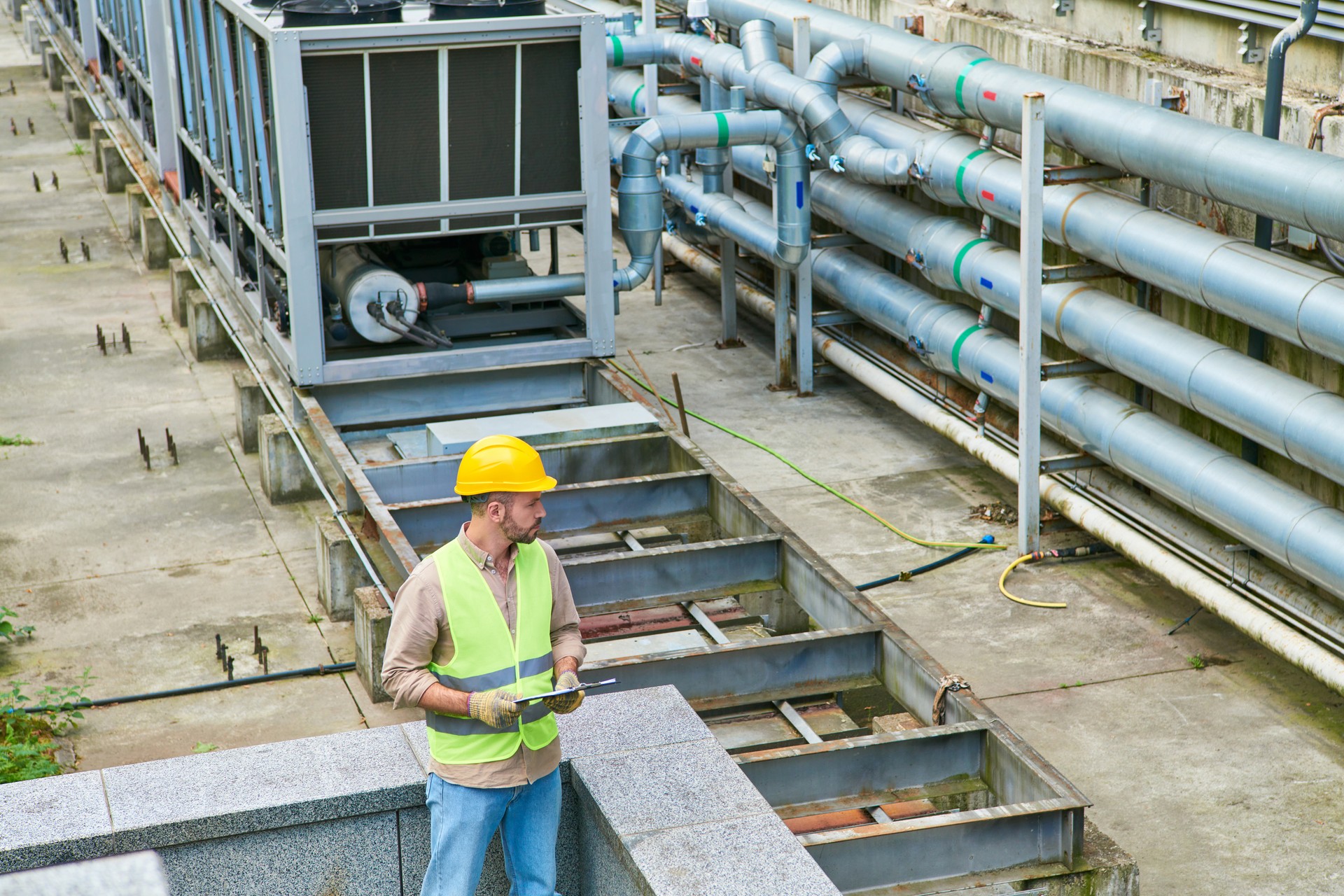 Focused technician working diligently in a busy data center with equipment nearby