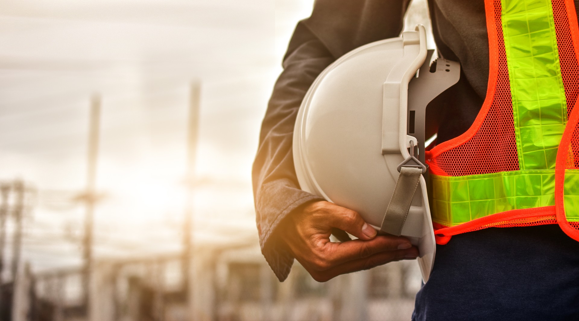 Technician holding white hat safety hard hat sunlight background